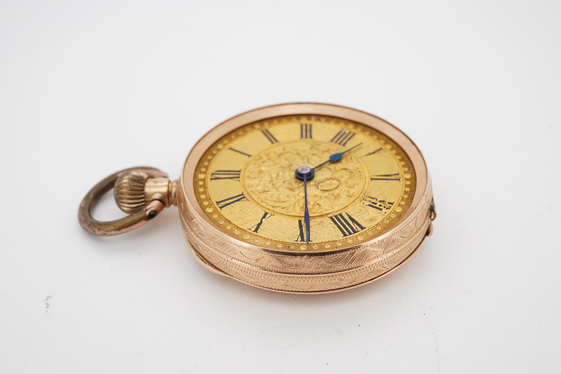 A lady's late 19th century Swiss engraved 14k keyless open faced fob watch, lacking glass, case diameter 32mm, with gilt metal inner cuvette, gross weight 27.6 grams.